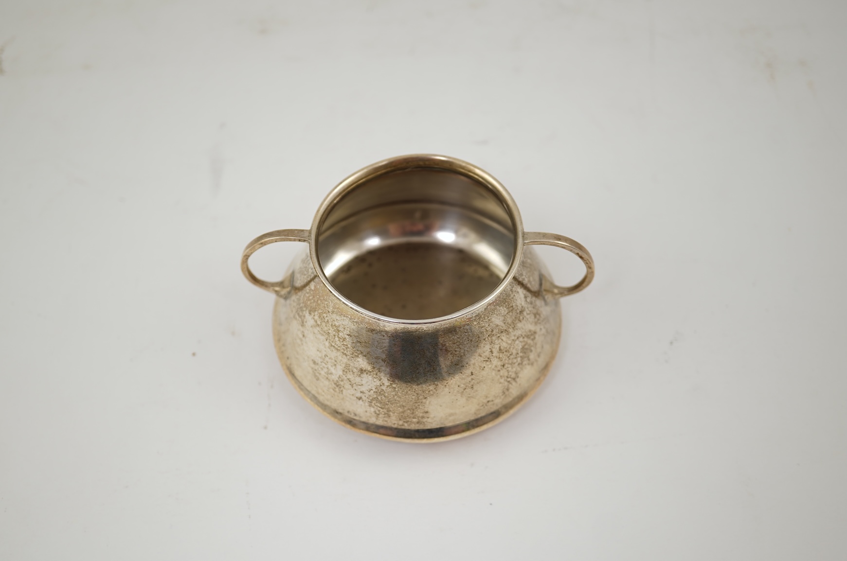 An Edwardian silver bachelor's two handled sugar bowl and matching sugar tongs, by Liberty & Co